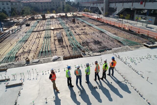 Construction workers standing at the construction site.